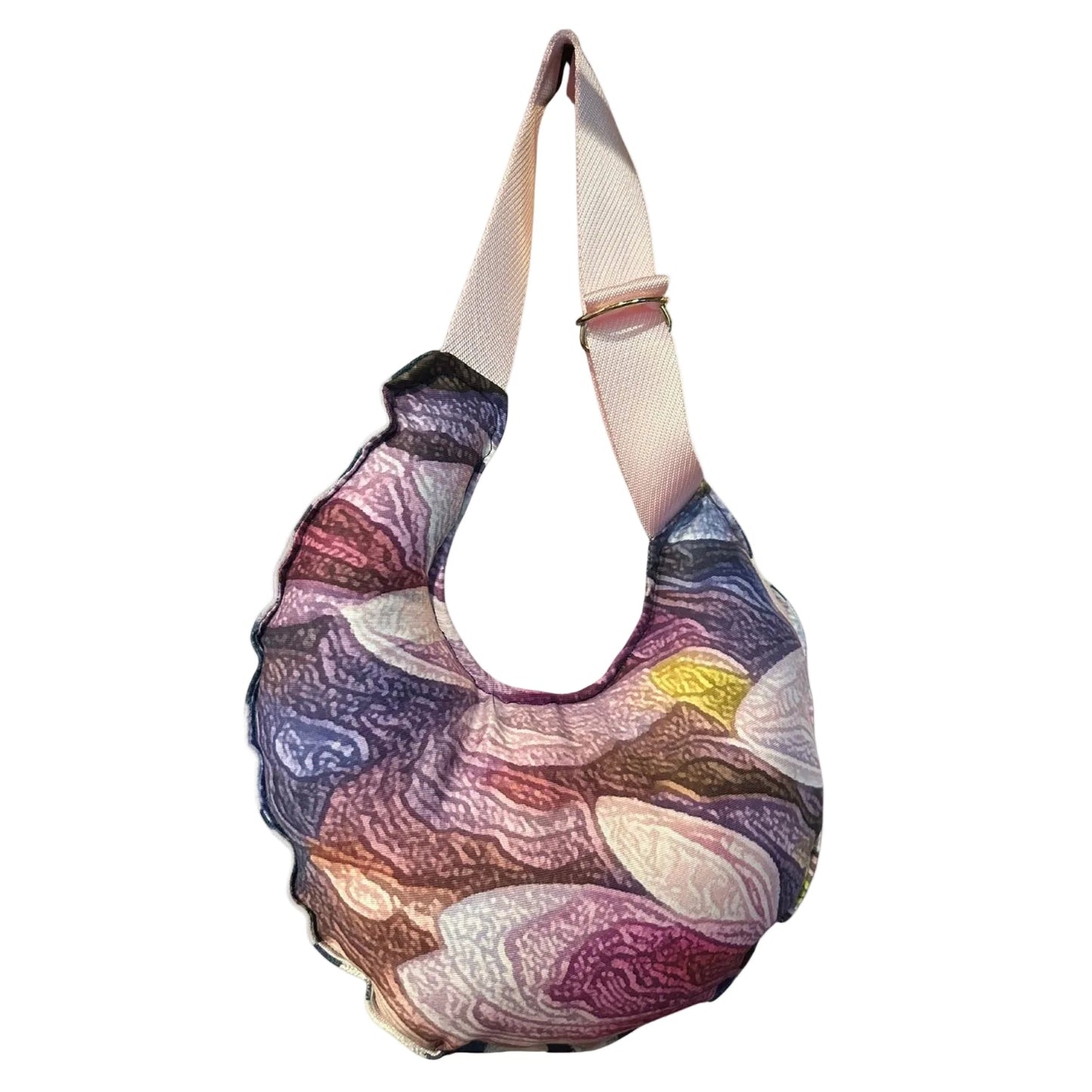 A crescent-shaped shoulder bag with a multicolor abstract marbled pattern in purple, pink, blue, and brown, featuring a wide beige shoulder strap.